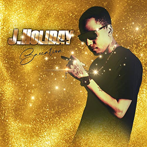 Album cover featuring a man in black against a gold glitter background.