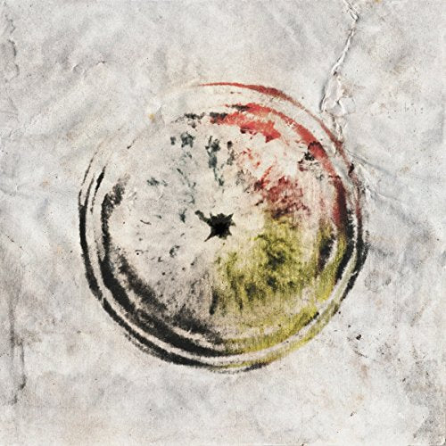 The image depicts a CD with a multicolored, abstract design on a textured background. For accessibility purposes, a suitable alt text could be: "CD with multicolored abstract design on a textured white background."