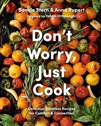 Cookbook with colorful food images and classic recipes on its cover and pages inside.