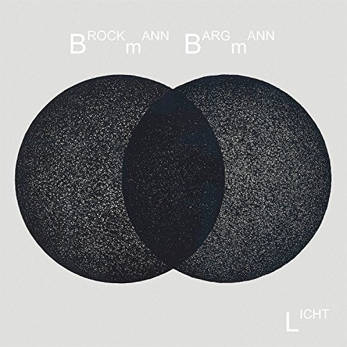 "Black vinyl records with speckled texture, overlapping, on a light grey background."