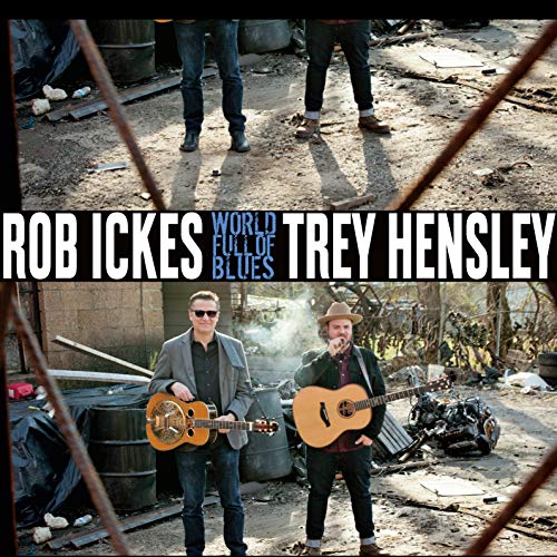 Album cover featuring two men holding guitars in a junkyard.