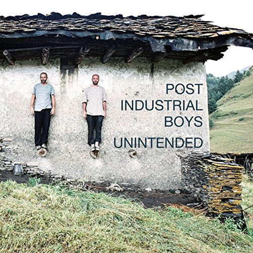 "Album cover featuring two men stuck to a crumbling wall with text."