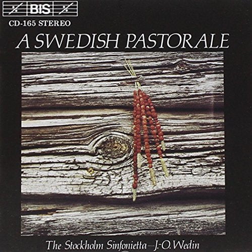 A CD cover featuring a wooden surface with red berries hanging from it.