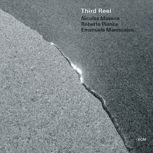 "Album cover with a grey, cracked surface and artist names in the top right."