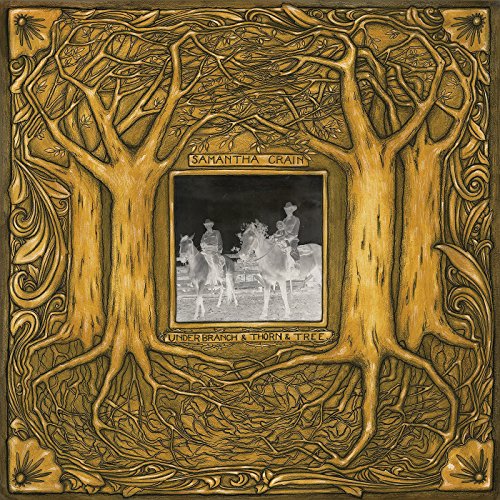 "CD cover art with embossed tree design and central black-and-white photograph."