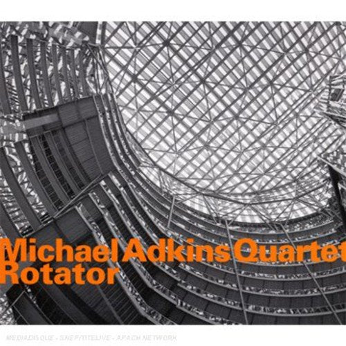"CD cover with black and white metal structure image and orange text."