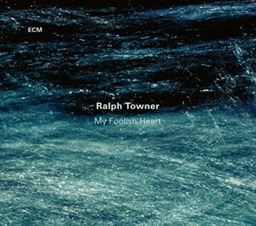 "Album cover with dark blue, textured background and white text, featuring Ralph Towner's 'My Foolish Heart'."