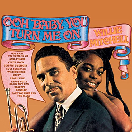 "Album cover with man holding trumpet and woman, orange background, and decorative text banners."