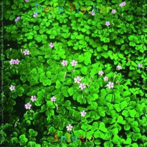 The alt text for the image is: "Dense green foliage with small purple flowers and multicolored text overlay."