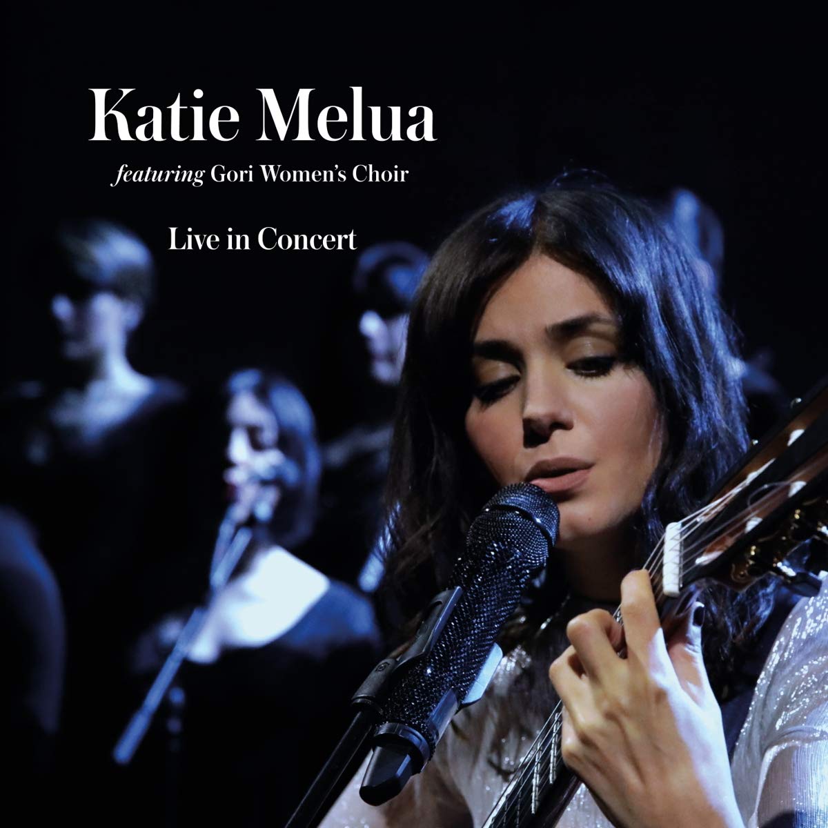 "CD cover of Katie Melua, featuring a woman singing into a microphone with a guitar."