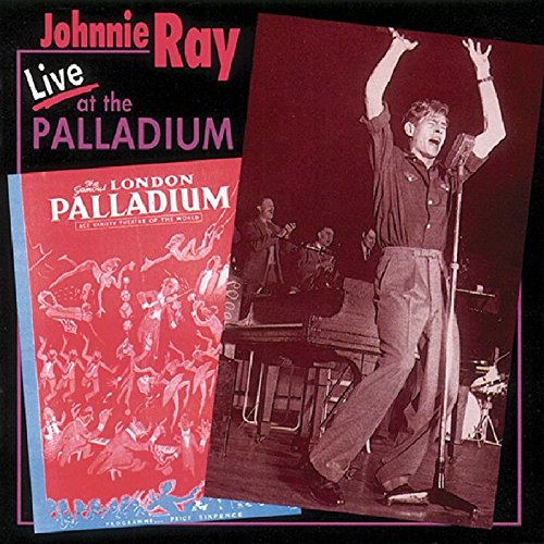 "CD cover featuring a singer on stage with arms raised, red and black design."