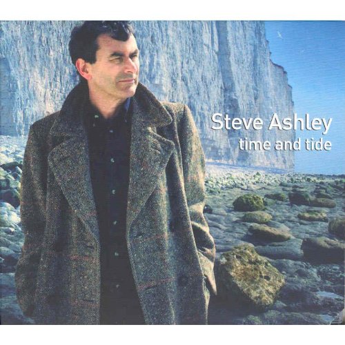 "Album cover featuring a man standing on a rocky shore with a cliff."