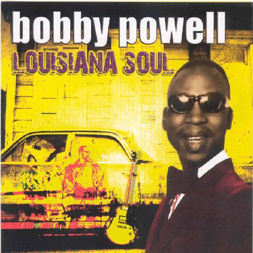 Album cover featuring a man in sunglasses and a suit, with a guitar and car.