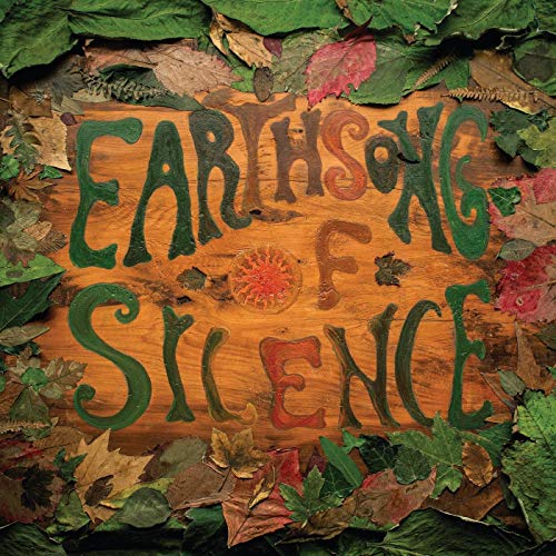 "Album cover with 'EARTHSONG OF SILENCE' written on wood, surrounded by leaves."