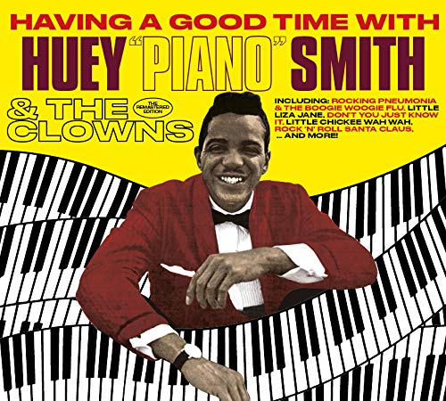 The image is a CD cover featuring a man in a red jacket and black bow tie, leaning on a piano keyboard. The text "Having a Good Time with Huey 'Piano' Smith & The Clowns" is prominently displayed, with the title "Having a Good Time with Huey 'Piano' Smith" in red and maroon font at the top. Alt-text: A smiling man in a red jacket and black bow tie leans on a piano keyboard, surrounded by yellow