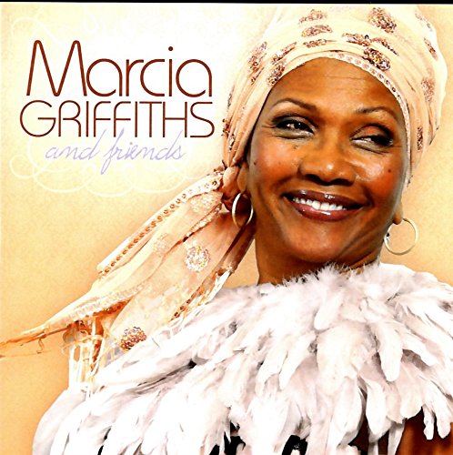 "Album cover featuring Marcia Griffiths smiling, wearing a headscarf and feathered top."