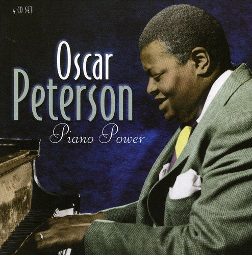 "CD cover featuring Oscar Peterson playing piano, wearing a suit, against a blue background."