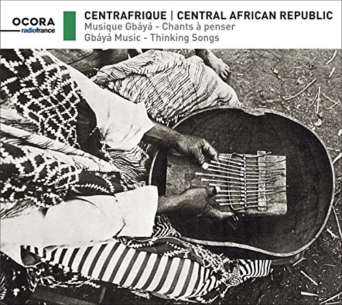 "Black and white CD cover with a man playing a stringed instrument outdoors."