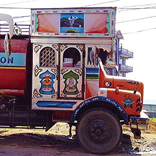 A decorated truck with colorful designs and paintings on its body and cab.