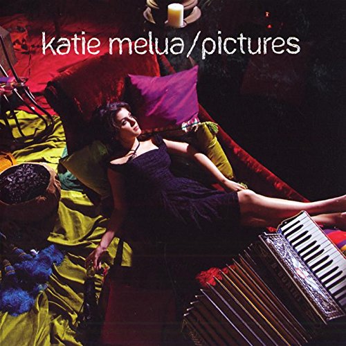 "Katie Melua's album cover, featuring a woman reclining on a colorful fabric with a keyboard."