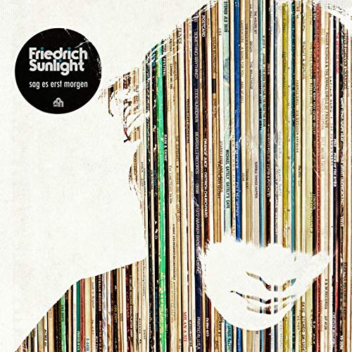 The vinyl album cover features a white silhouette with multicolored book spines.