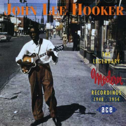 "CD cover featuring John Lee Hooker playing guitar on a city sidewalk."