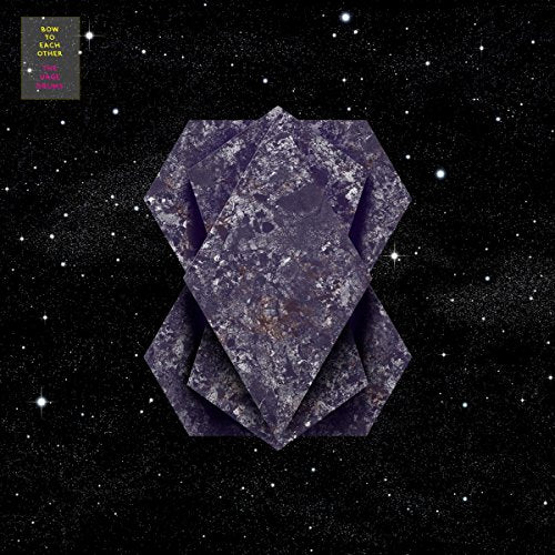 A vinyl record cover featuring a purple, geometric shape against a starry black background.