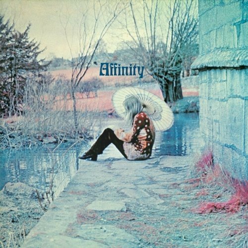 The image depicts a serene scene with a person sitting on a stone path. For accessibility purposes, a suitable alt text could be: "Album cover featuring a person sitting on a stone path."