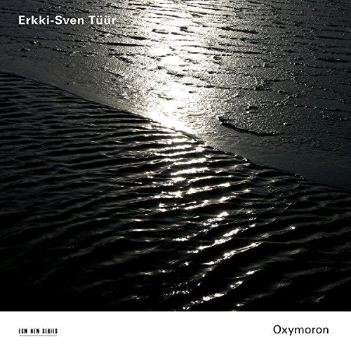 "Album cover with dark, rippled water reflecting sunlight, artist and title text."