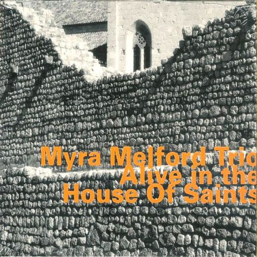 "Album cover with orange text on a black-and-white image of a stone wall."