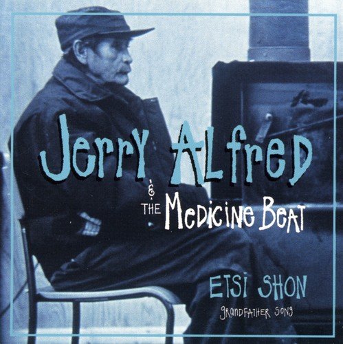 "Album cover with man sitting by a piano, wearing a cap and dark clothing."