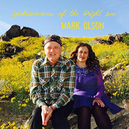 "Album cover with man and woman sitting together in a field of yellow flowers."