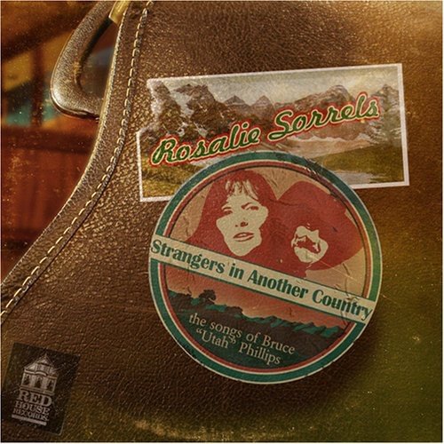 "CD case with brown leather cover, featuring a circular album cover and landscape image."
