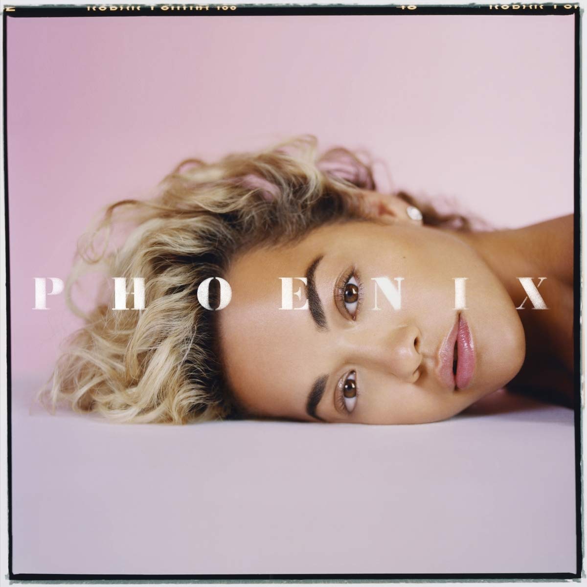 "CD album cover with blonde woman's head on a pink background, 'Phoenix' text overlay."