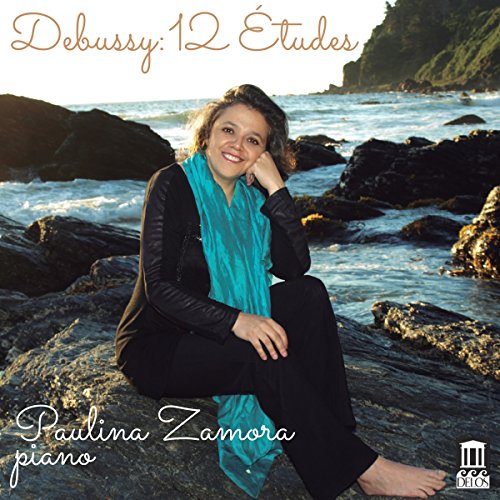 A woman sits on a rocky shore, wearing a blue scarf, on a CD cover.