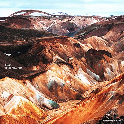 "Album cover featuring a landscape of brown and orange hills with text."