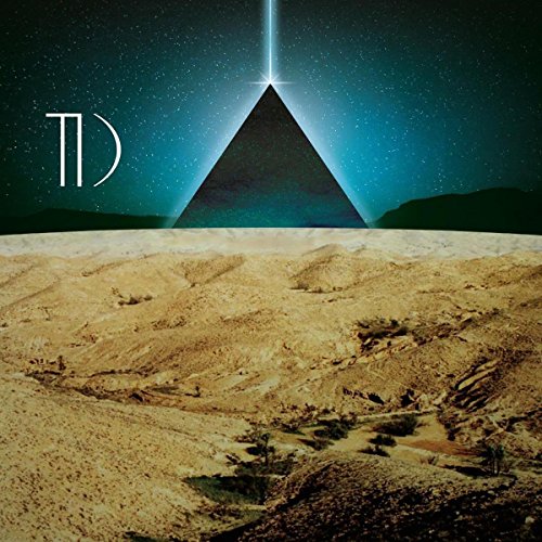 A pyramid glows under a starry night sky, with a desert landscape in the foreground.
