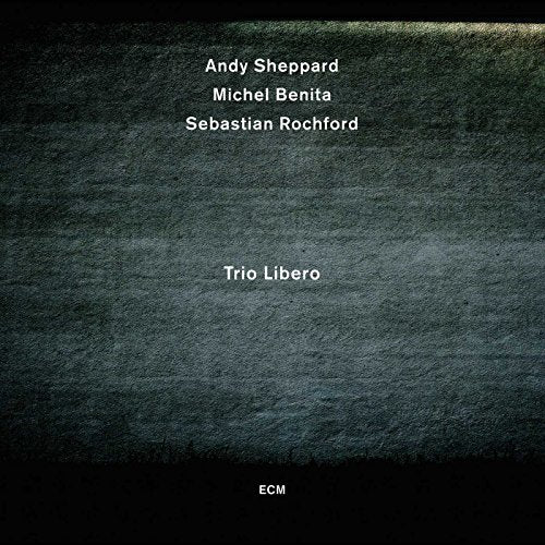 "Album cover with dark, textured background and white text listing artist names and album title."