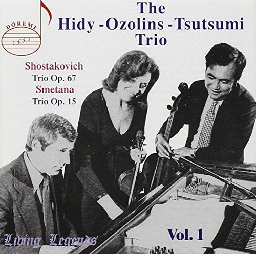 Black-and-white photo of three musicians on a CD cover with text overlays.