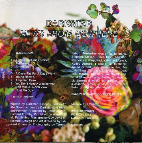 The image shows a multicolored bouquet of flowers and foliage. Alt text: Colorful bouquet with rainbow rose and iridescent leaves.