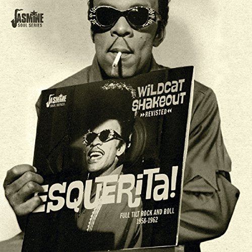 Man holding CD cover with image of another man wearing sunglasses.