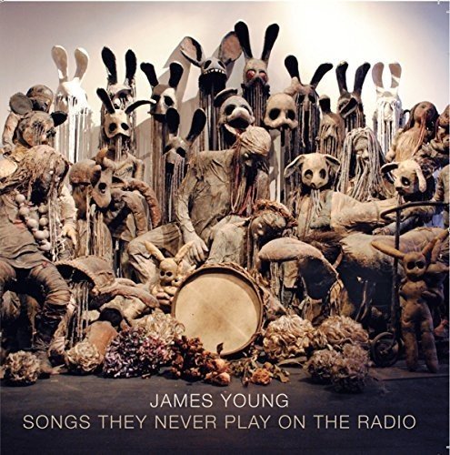 CD cover featuring a group of strange, textured figures with masks.