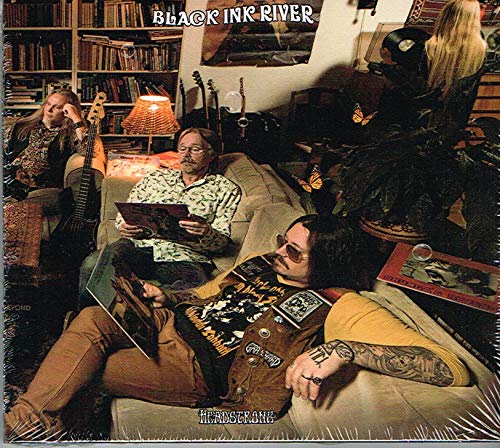 "Album cover: 'Black Ink River - Headstrong' featuring a band in a cozy living room."