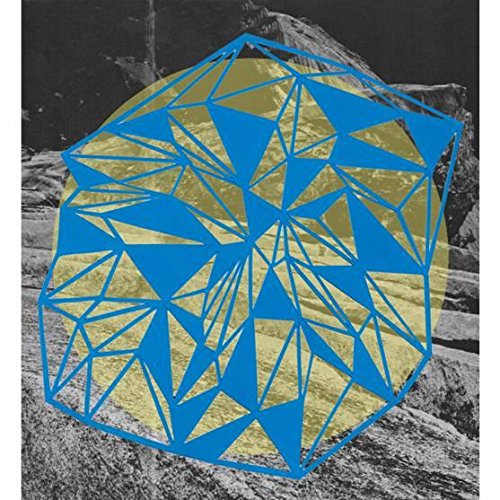 A vinyl record cover featuring a blue geometric shape over a rocky landscape.