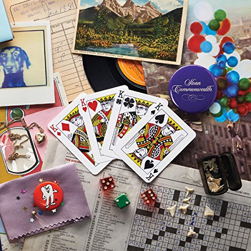 "CD case with 'Sloan Commonwealth' on a purple tin, surrounded by miscellaneous objects and memorabilia."