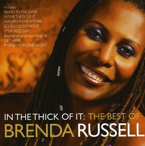 "CD cover featuring a smiling woman with braided hair and gold and white text."