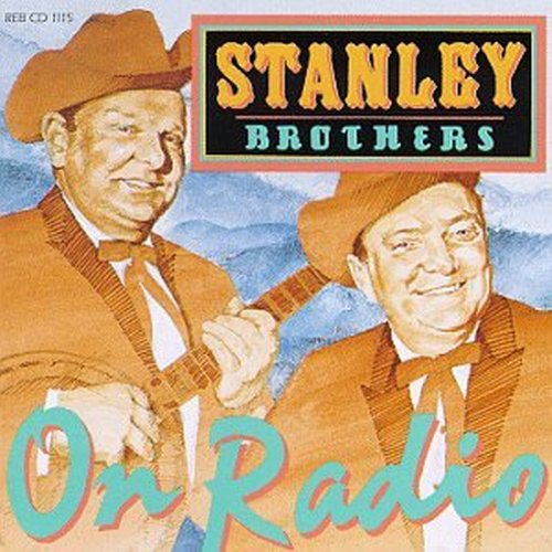"CD cover art featuring two men in suits holding a banjo, mountains in background."