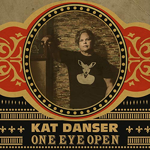 Album cover with a man in a black shirt, surrounded by ornate gold and red design.