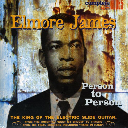"Elmore James album cover with a man in a suit against a rusty metal background."