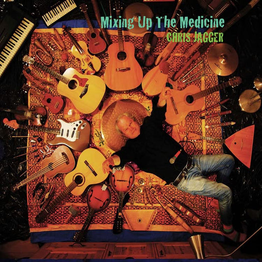 Album cover: Chris Jagger surrounded by various stringed instruments.